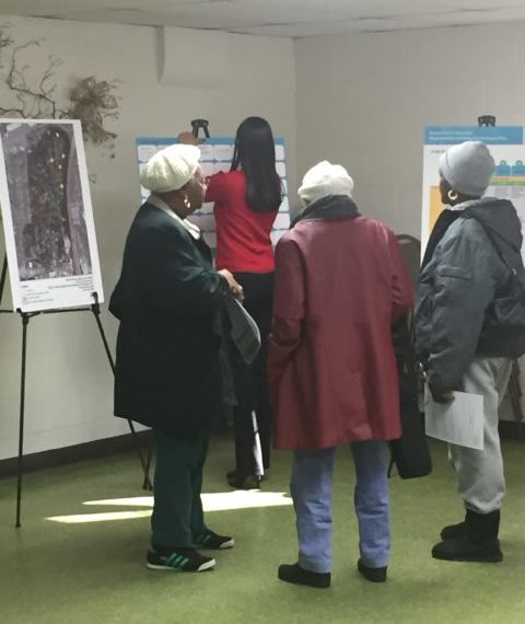 Burton community members looking at meeting baords