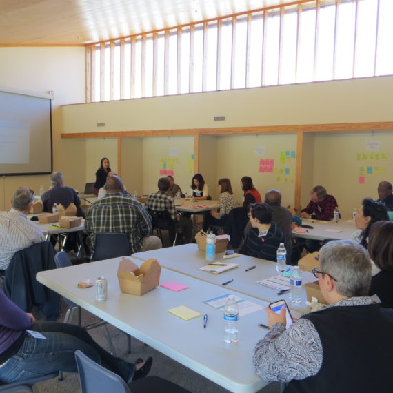 Community members sitting around tables