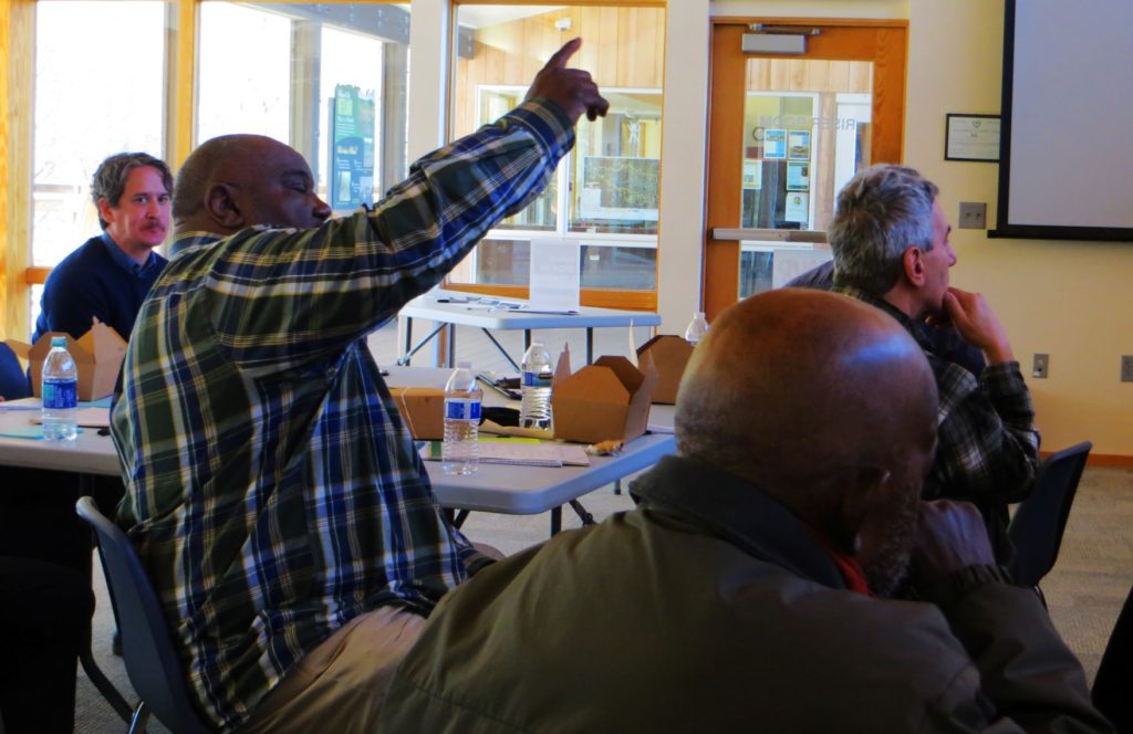 Man raising his hand to ask a question